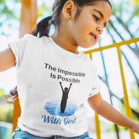 Bella+Canvas toddler t-shirt with “Impossible Toddler” design and faith-filled message, soft cotton, breathable and durable, Christian apparel for active toddlers and family matching, toddler girl in white t-shirt