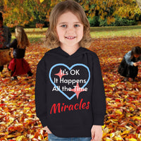 Rabbit Skins toddler fleece hoodie with “Miracles Happen” design and uplifting message, soft cotton-poly blend, jersey-lined hood, Christian apparel for cozy wear and faith-filled gifting, toddler girl in black hoodie