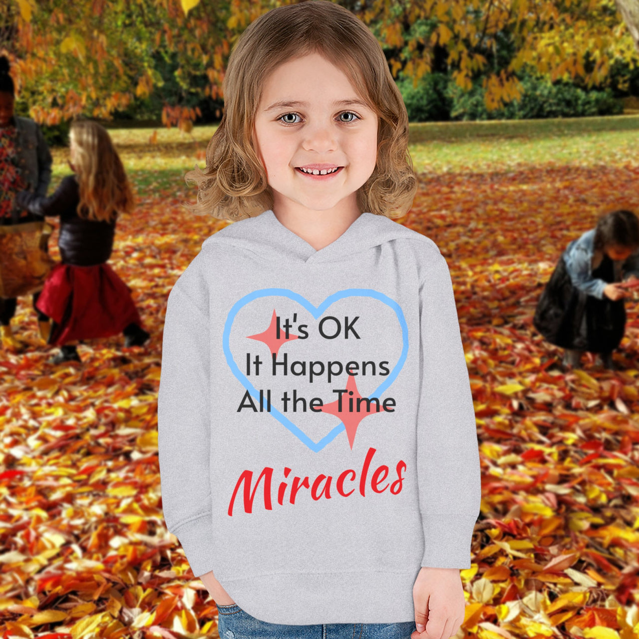 Rabbit Skins toddler fleece hoodie with “Miracles Happen” design and uplifting message, soft cotton-poly blend, jersey-lined hood, Christian apparel for cozy wear and faith-filled gifting, toddler girl in gray hoodie