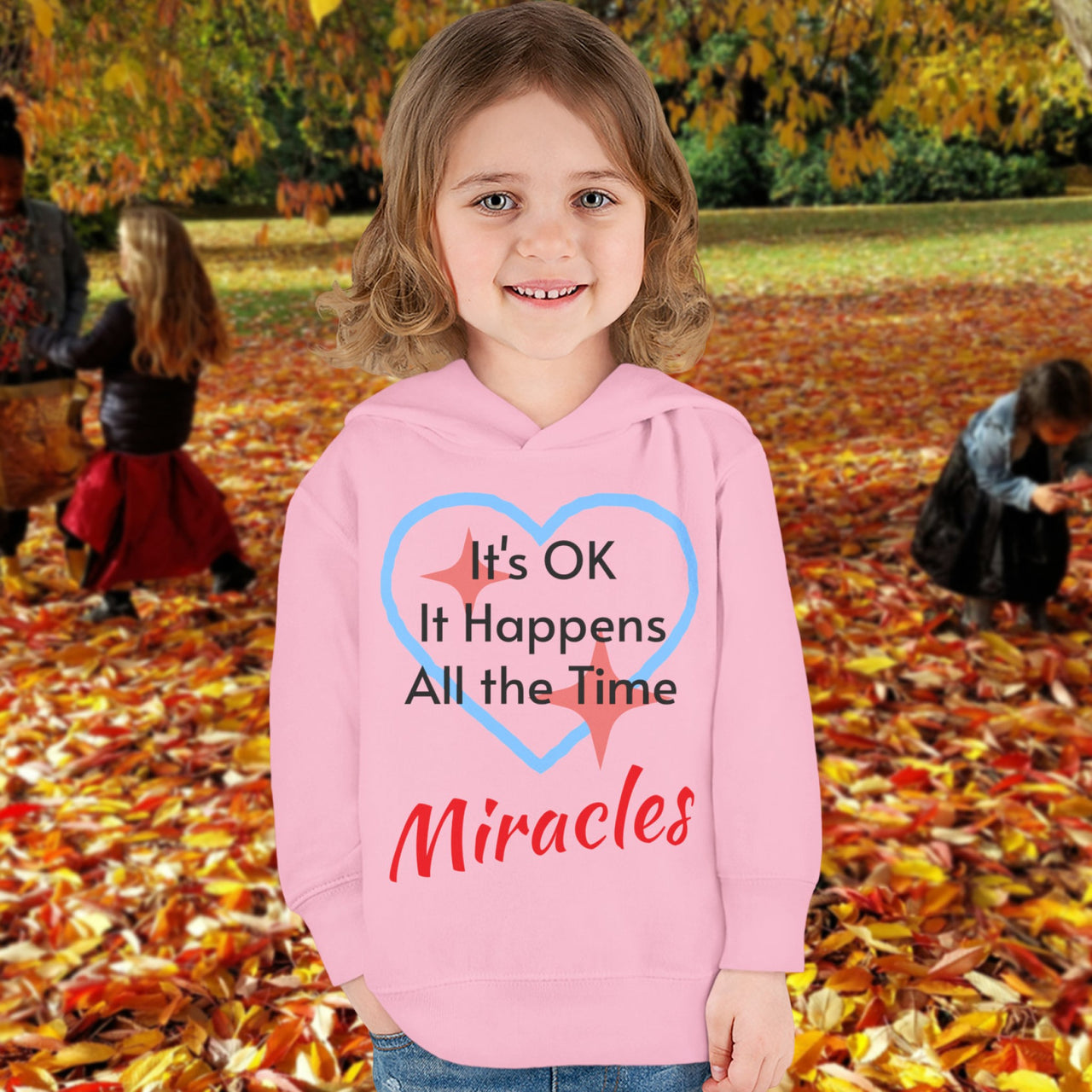 Rabbit Skins toddler fleece hoodie with “Miracles Happen” design and uplifting message, soft cotton-poly blend, jersey-lined hood, Christian apparel for cozy wear and faith-filled gifting, toddler girl in pink hoodie