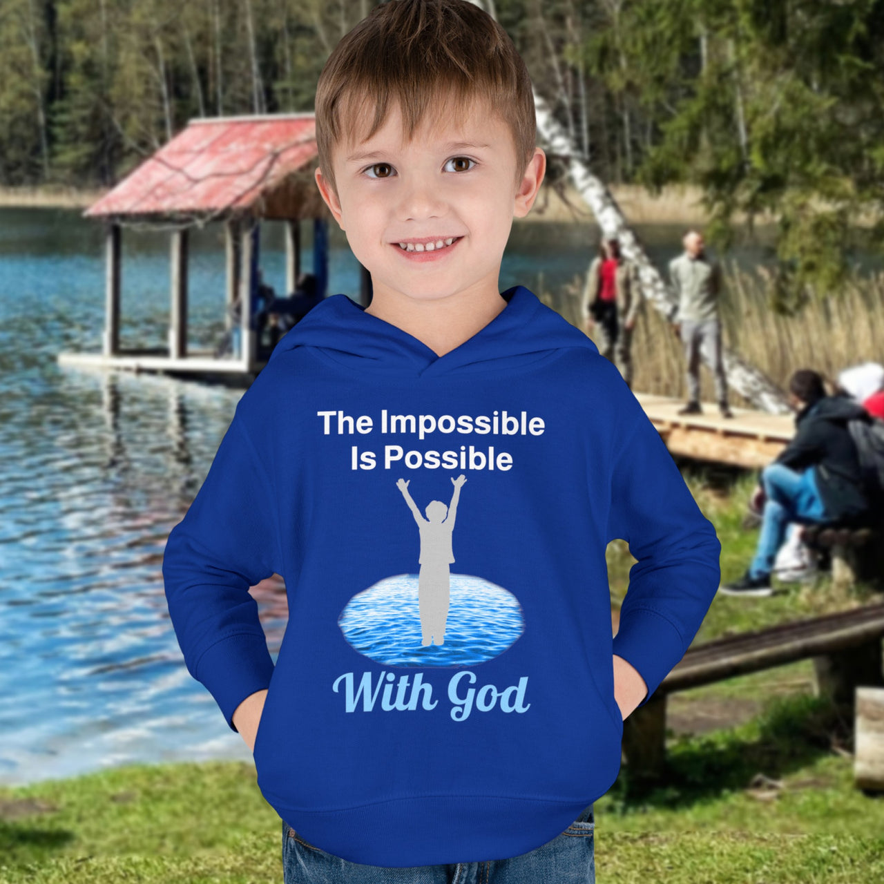 Rabbit Skins toddler fleece hoodie with “Impossible Toddler” design and faith-filled message, soft cotton-poly blend, durable stitching, Christian apparel for active toddlers and spiritual encouragement, toddler boy in blue hoodie