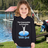 Rabbit Skins toddler fleece hoodie with “Impossible Toddler” design and faith-filled message, soft cotton-poly blend, durable stitching, Christian apparel for active toddlers and spiritual encouragement, toddler girl in black hoodie