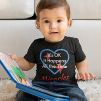Bella+Canvas baby t-shirt with “Miracles Happen” design and uplifting message, soft cotton, breathable and durable, Christian apparel for infants and family matching, baby boy in black shirt