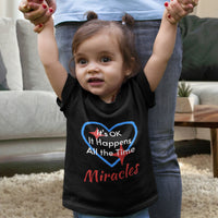 Bella+Canvas baby t-shirt with “Miracles Happen” design and uplifting message, soft cotton, breathable and durable, Christian apparel for infants and family matching, baby girl in black shirt
