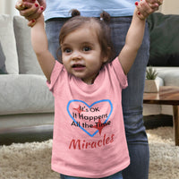 Bella+Canvas baby t-shirt with “Miracles Happen” design and uplifting message, soft cotton, breathable and durable, Christian apparel for infants and family matching, baby girl in pink shirt