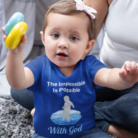 Bella+Canvas baby t-shirt with “Impossible Baby” design and faith-filled message, soft cotton, breathable and durable, Christian apparel for infants and family matching, baby girl in blue shirt