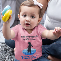 Bella+Canvas baby t-shirt with “Impossible Baby” design and faith-filled message, soft cotton, breathable and durable, Christian apparel for infants and family matching, baby girl in pink shirt