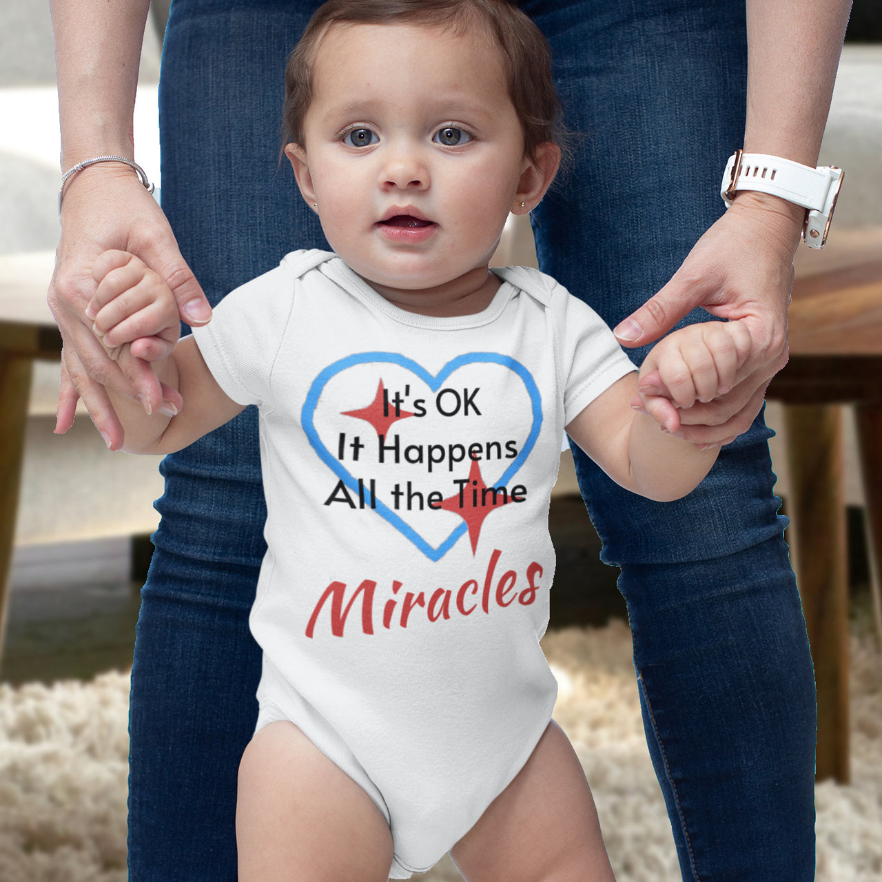 Bella+Canvas baby onesie with “Miracles Happen” design and uplifting message, soft cotton, envelope neck and snap closure, Christian apparel for infants and family matching, baby girl in white onesie