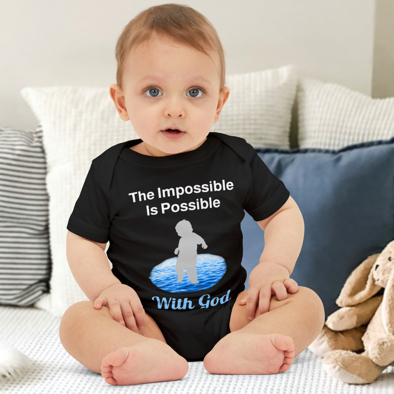 Bella+Canvas baby onesie with “Impossible Baby” design and faith-filled message, soft cotton, envelope neck and snap closure, Christian apparel for infants and spiritual encouragement, baby boy in black onesie