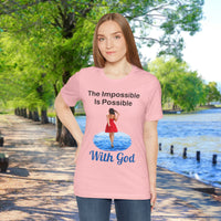Soft, breathable Bella+Canvas t-shirt made from preshrunk cotton with “Impossible Woman” design message, “The Impossible Is Possible with God,” inspirational shirt encouraging bold obedience and faith-filled movement with God, woman in pink t-shirt at waterside walkway