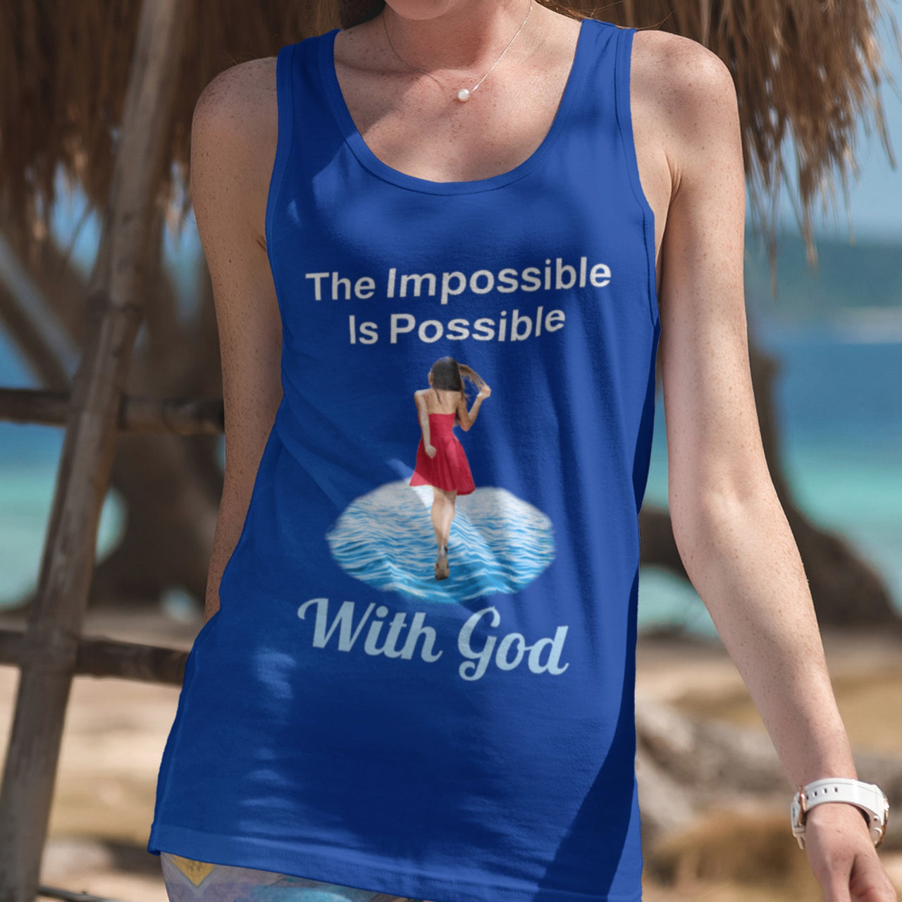 Lightweight Bella+Canvas tank top made from preshrunk cotton with “Impossible Woman” design message, “The Impossible Is Possible with God,” inspirational apparel encouraging women to walk in step with God who makes our impossible dreams become real, woman wearing blue tank top