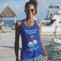 Lightweight Bella+Canvas tank top made from preshrunk cotton with “Impossible Woman” design message, “The Impossible Is Possible with God,” inspirational apparel encouraging women to walk in step with God who makes our impossible dreams become real, woman at beach wearing blue tank