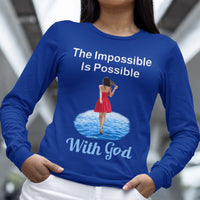 Long-sleeve Bella+Canvas t-shirt made from preshrunk ring-spun cotton with “Impossible Woman” design message, “The Impossible Is Possible with God,” inspirational apparel encouraging women to walk freely in God's incredible ways, woman wearing blue long-sleeve t-shirt
