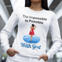 Long-sleeve Bella+Canvas t-shirt made from preshrunk ring-spun cotton with “Impossible Woman” design message, “The Impossible Is Possible with God,” inspirational apparel encouraging women to walk freely in God's incredible ways, woman in white long-sleeve t-shirt