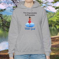 Gildan unisex hoodie with “Impossible Woman” design featuring a woman walking on water and uplifting message, Christian apparel made from soft cotton-poly blend, ideal for cold weather and faith-forward style, woman in gray hoodie