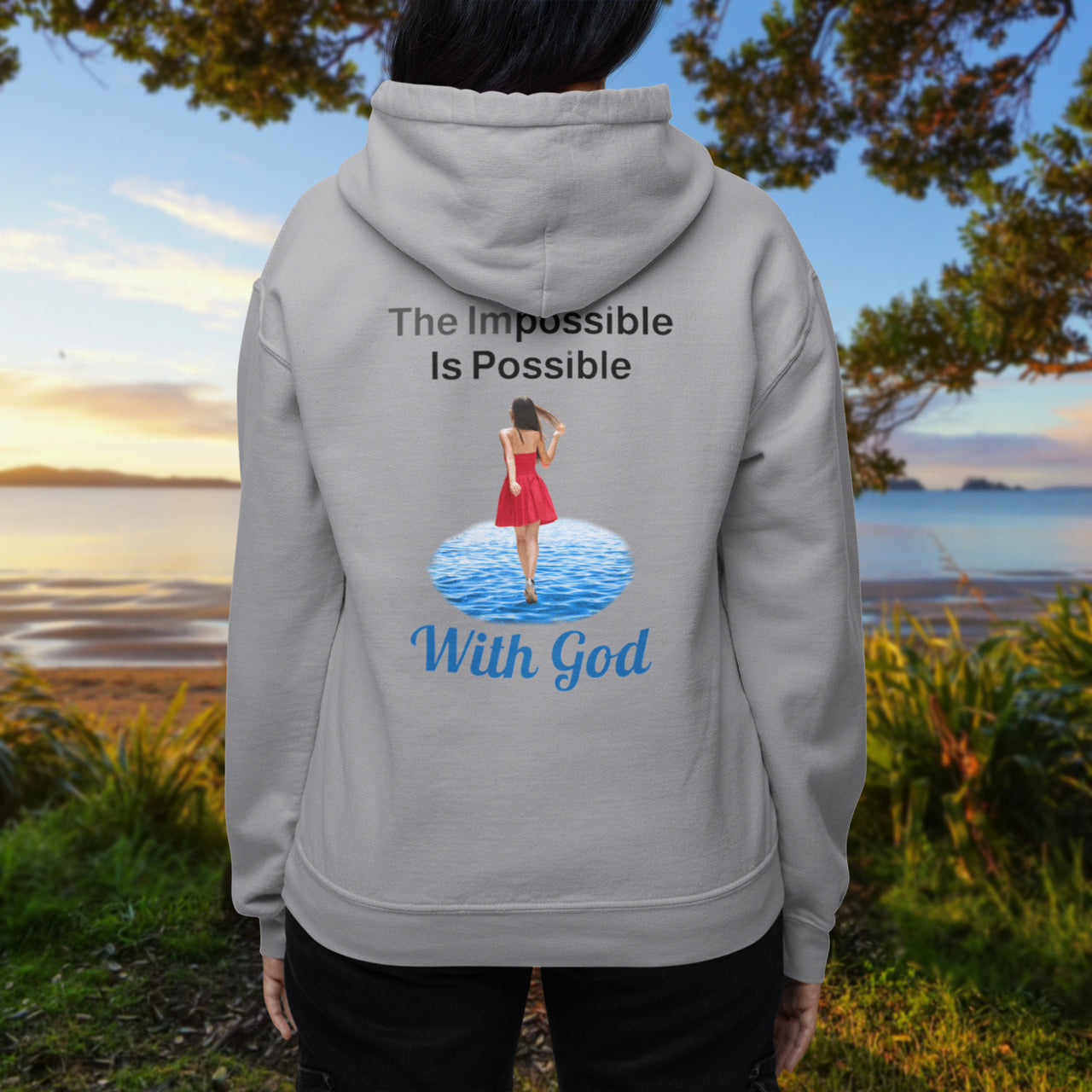 Gildan unisex zip-up hoodie with “Impossible Woman” design featuring a woman walking on water and uplifting message, Christian apparel made from soft cotton-poly fleece, ideal for cooler weather and faith-forward style, woman in gray hoodie
