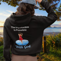 Gildan unisex zip-up hoodie with “Impossible Woman” design featuring a woman walking on water and uplifting message, Christian apparel made from soft cotton-poly fleece, ideal for cooler weather and faith-forward style, 2nd woman in black hoodie