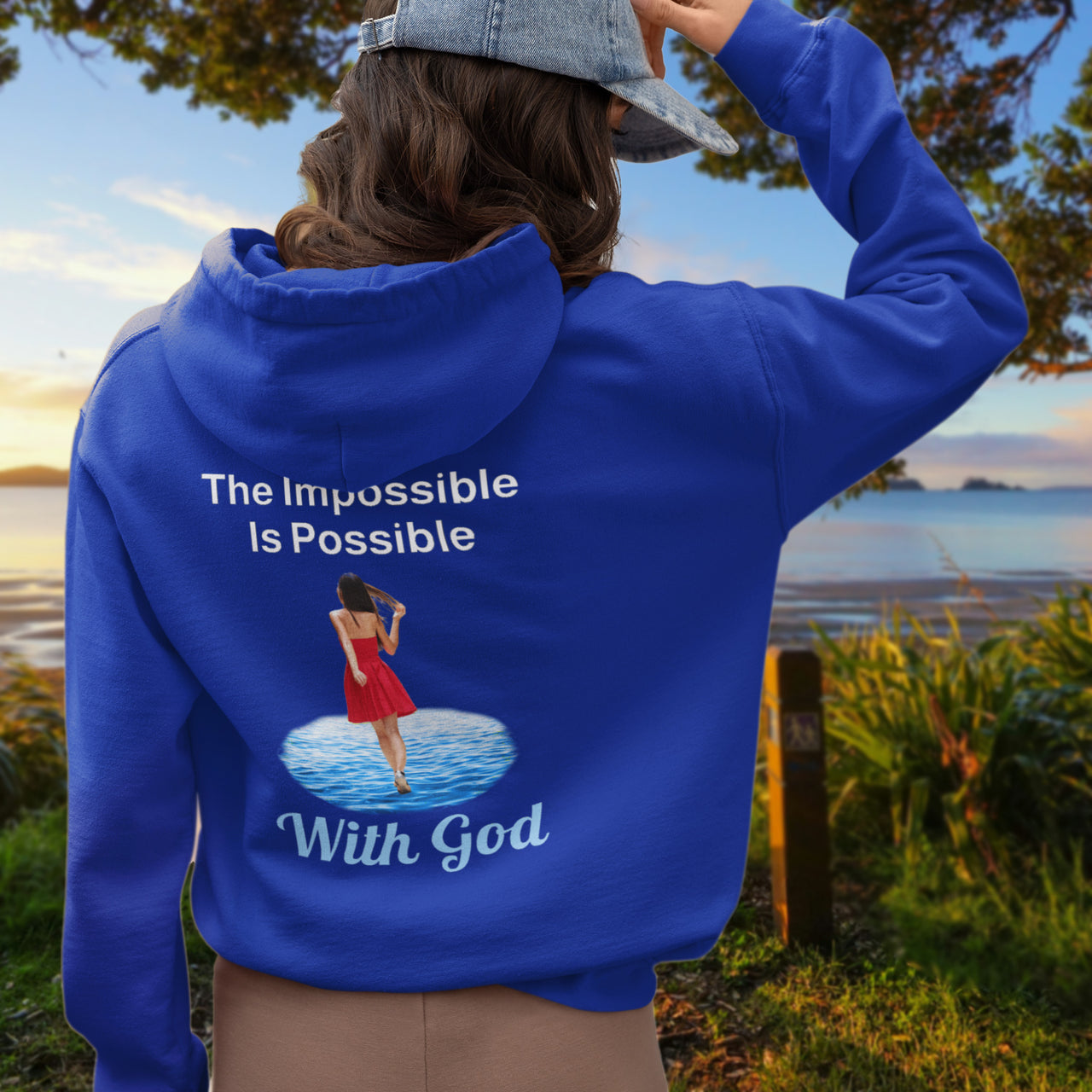 Gildan unisex zip-up hoodie with “Impossible Woman” design featuring a woman walking on water and uplifting message, Christian apparel made from soft cotton-poly fleece, ideal for cooler weather and faith-forward style, 2nd woman in blue hoodie