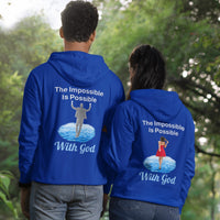 Gildan unisex zip-up hoodie with “Impossible Woman” design featuring a woman walking on water and uplifting message, Christian apparel made from soft cotton-poly fleece, ideal for cooler weather and faith-forward style, couple in blue hoodie