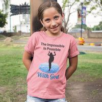 Bella+Canvas youth unisex t-shirt with “Impossible Girl” design featuring a girl walking on water and uplifting message, Christian apparel made from soft cotton, ideal for active wear and faith-forward style, young girl in pink t-shirt