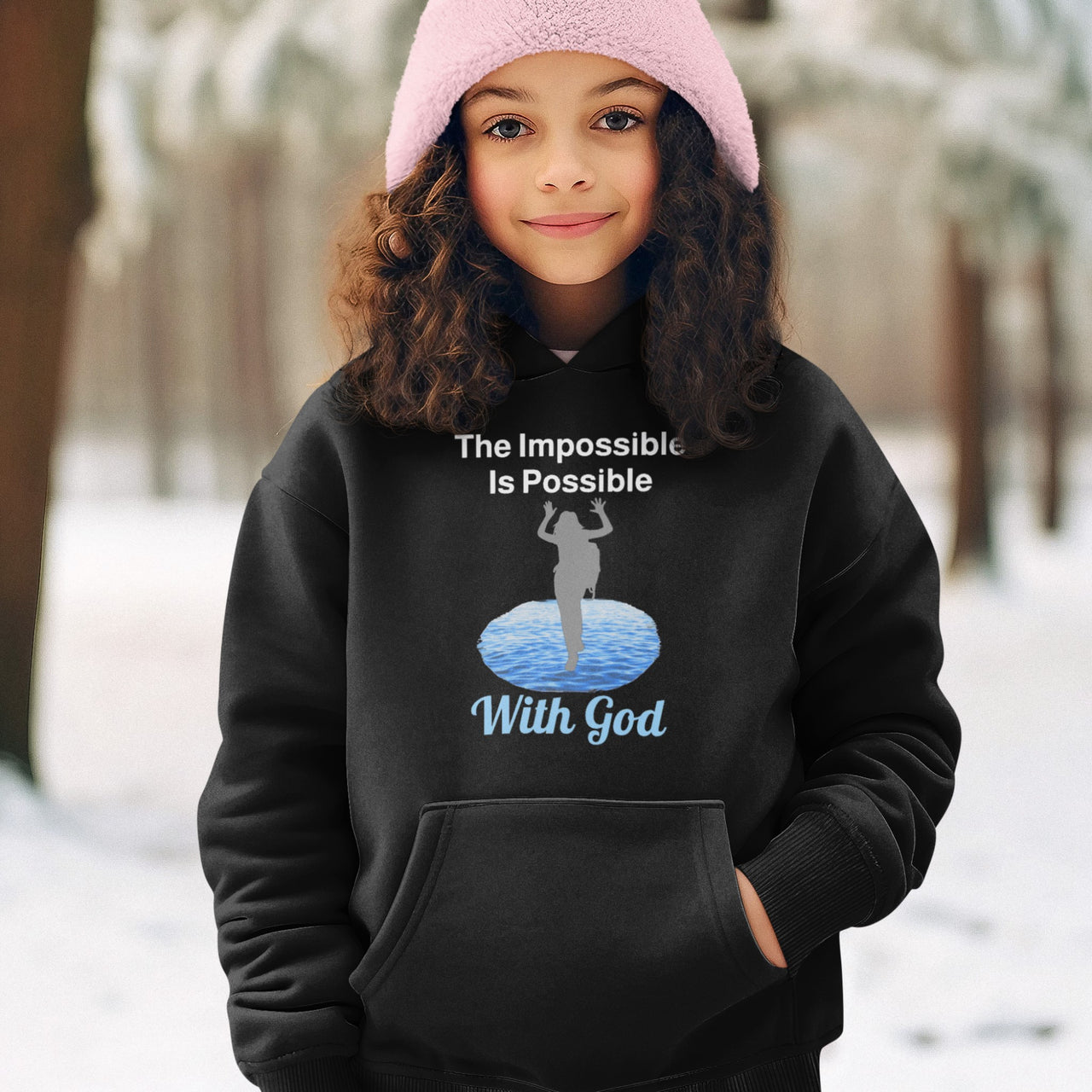 Gildan youth unisex hoodie with “Impossible Girl” design featuring a girl walking on water and uplifting message, Christian apparel made from soft preshrunk fleece, ideal for cooler weather and faith-forward style, girl in black hoodie