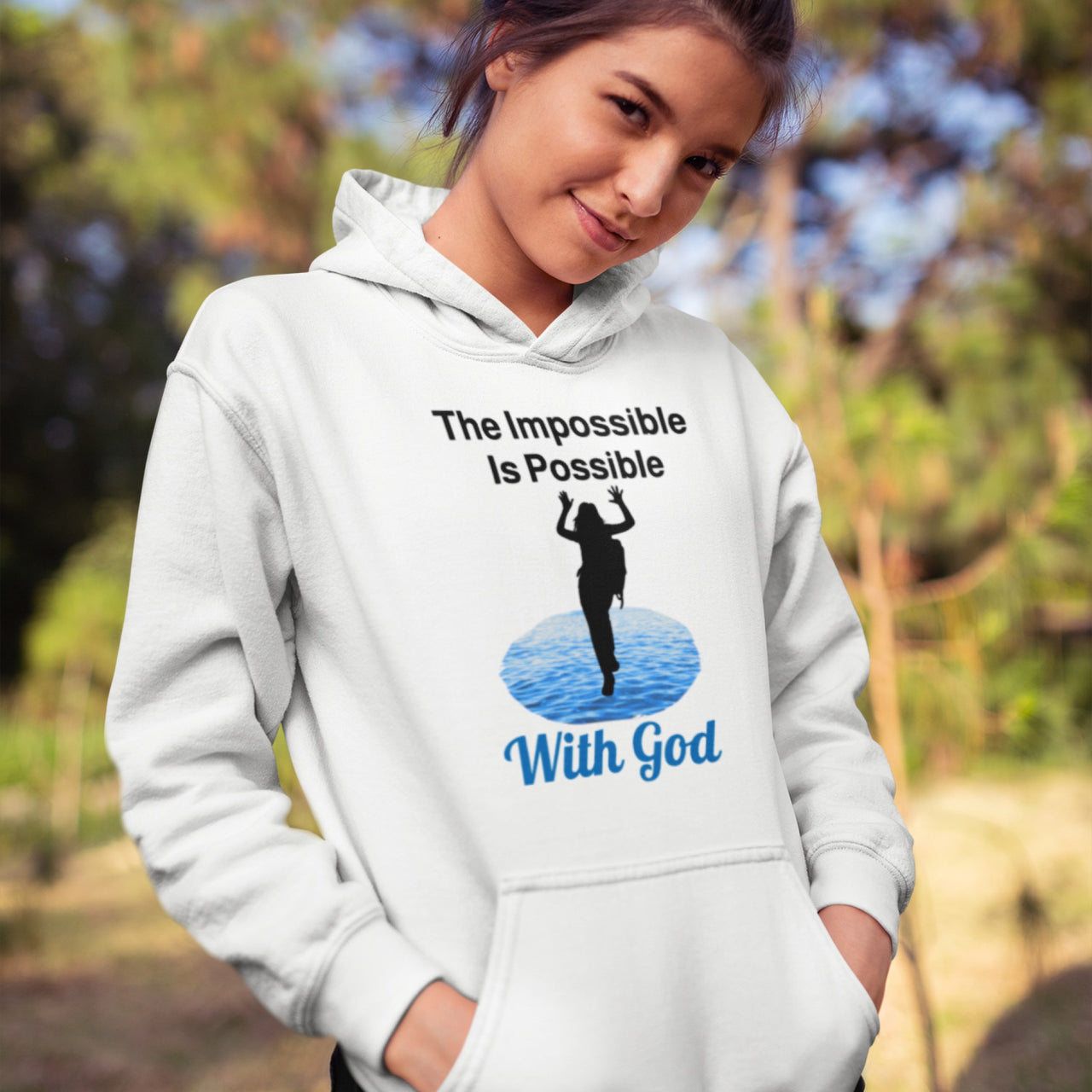 Gildan youth unisex hoodie with “Impossible Girl” design featuring a girl walking on water and uplifting message, Christian apparel made from soft preshrunk fleece, ideal for cooler weather and faith-forward style, teen girl in white hoodie