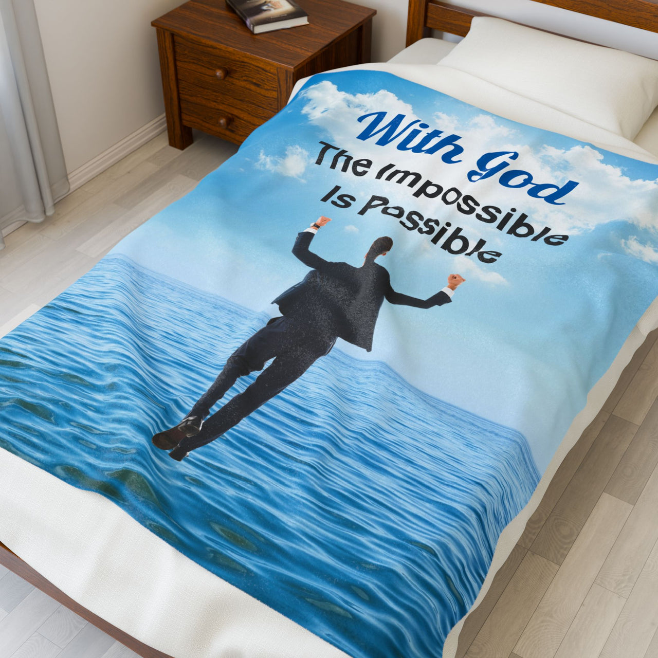 Faith-based plush blanket with “Impossible Man” design, man walking on water,  inspirational message "With God, The Impossible Is Possible," velveteen fabric, full print front, white back, throw and twin sizes, throw size on bed
