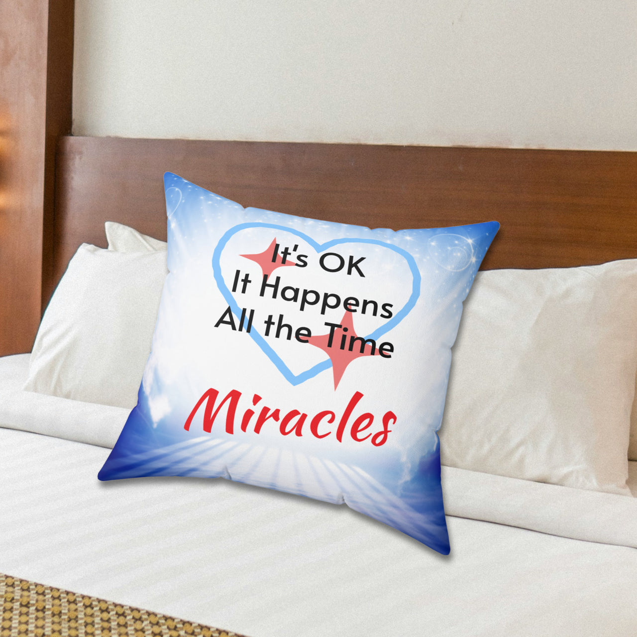 Inspirational throw pillow with “Miracles Happen” design with message "It's OK, It Happens All the Time - Miracle," reversible design, faith-based home décor, white or blue back, spun polyester, 4 sizes 20x20 on bed