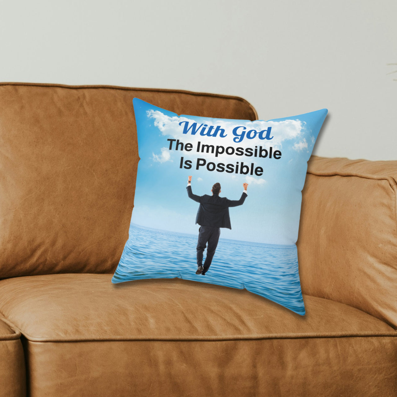 Faith-based throw pillow with “Impossible Man” design, man walking on water, inspirational message "With God, The Impossible Is Possible," inspirational home décor, reversible with white or sea blue back, spun polyester, 4 sizes, 14x14 on couch
