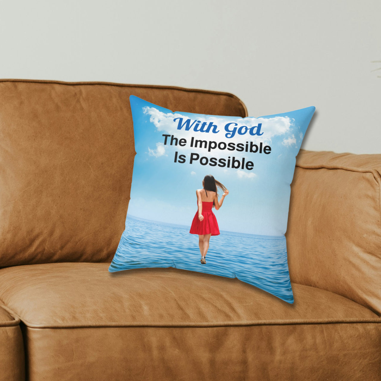 Inspirational throw pillow with “Impossible Woman” design, woman walking on water, spiritual message "With God, The Impossible Is Possible," faith-based home décor, reversible with sea blue back, spun polyester, 4 sizes, 14x14 on couch
