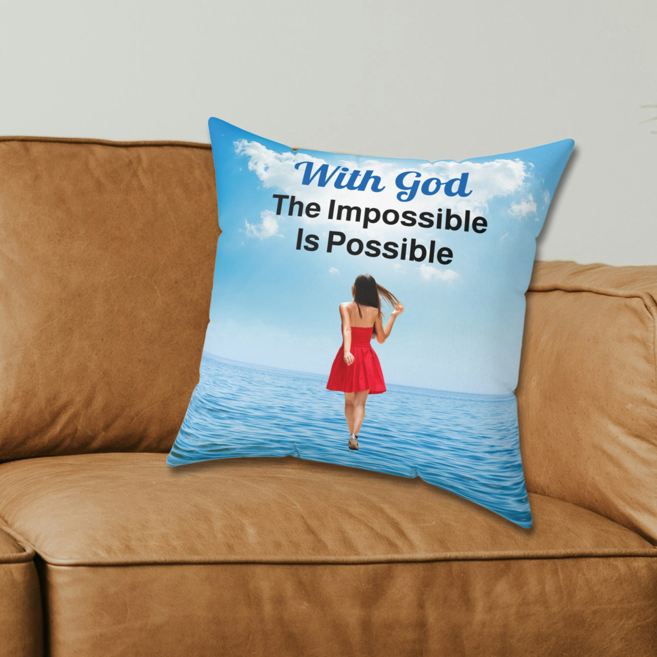 Inspirational throw pillow with “Impossible Woman” design, woman walking on water, spiritual message "With God, The Impossible Is Possible," faith-based home décor, reversible with sea blue back, spun polyester, 4 sizes, 16x16 on couch