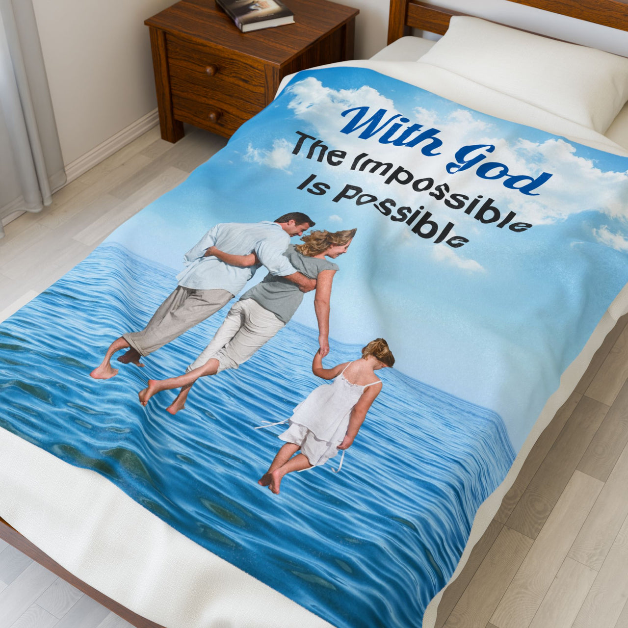 Faith-based plush blanket with “Impossible Family” design, family walking on water, faith-based message "With God, The Impossible Is Possible," inspirational home décor, velveteen fabric, full print front, white back, throw and twin sizes, throw size on bed
