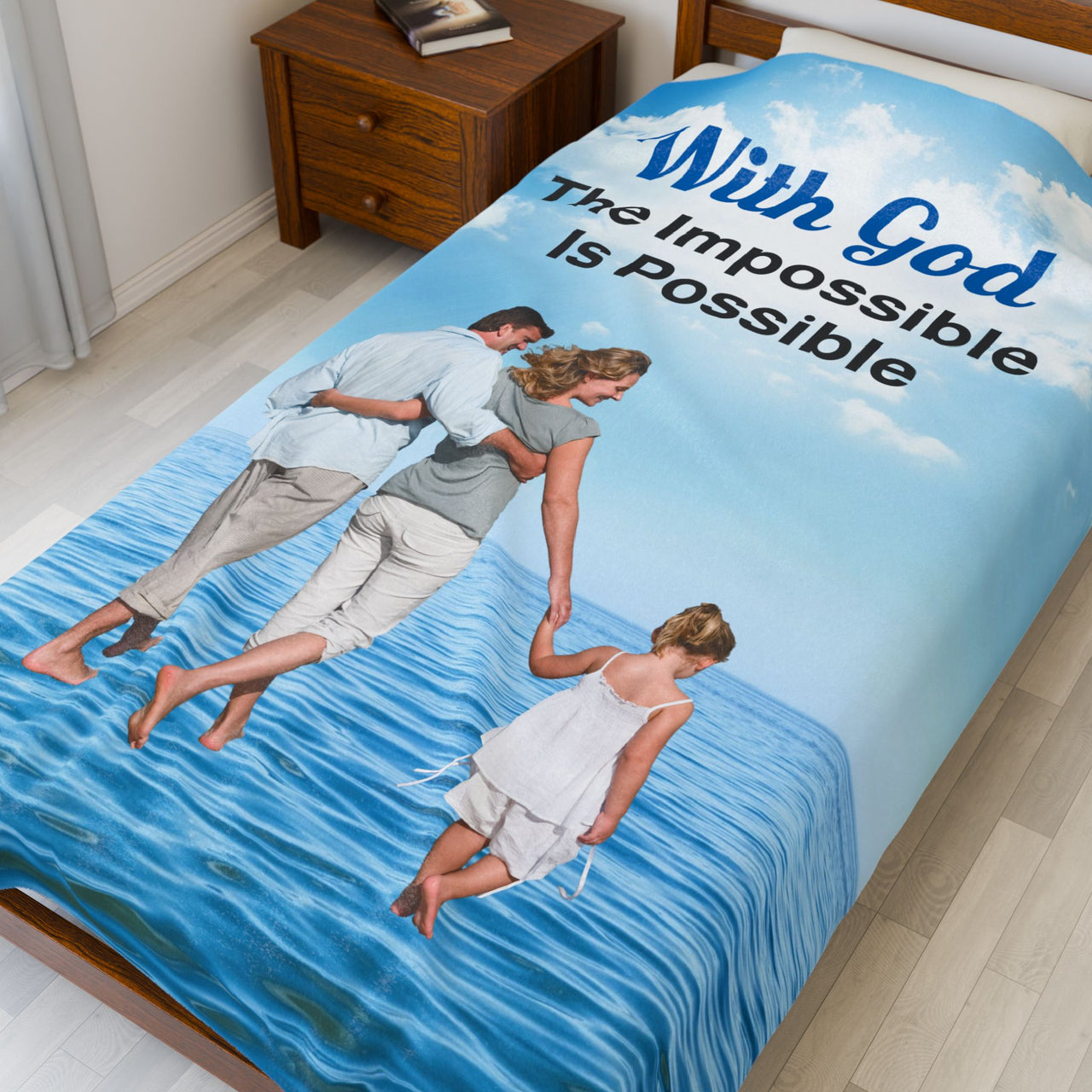 Faith-based plush blanket with “Impossible Family” design, family walking on water, faith-based message "With God, The Impossible Is Possible," inspirational home décor, velveteen fabric, full print front, white back, throw and twin sizes, twin size on bed