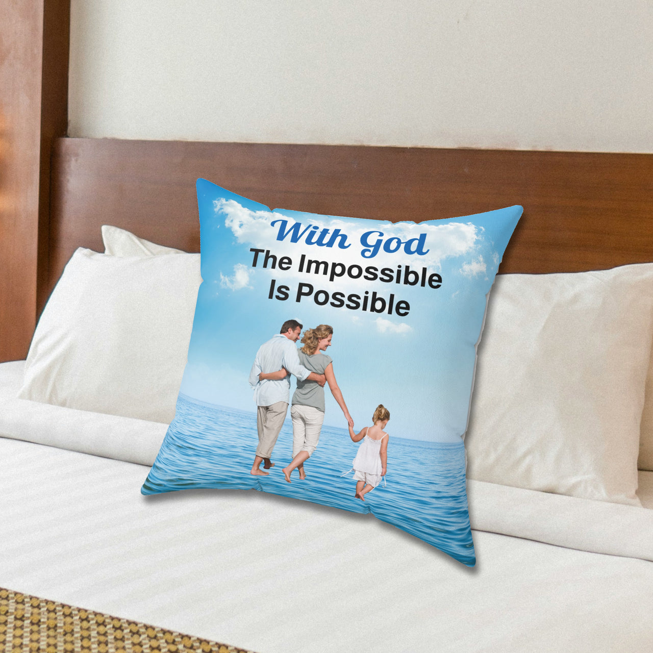 Faith-based throw pillow with “Impossible Family” design, family walking on water with message "With God, The Impossible Is Possible," inspirational home décor, reversible with white or sea blue back, spun polyester, 4 sizes, 20x20 on bed