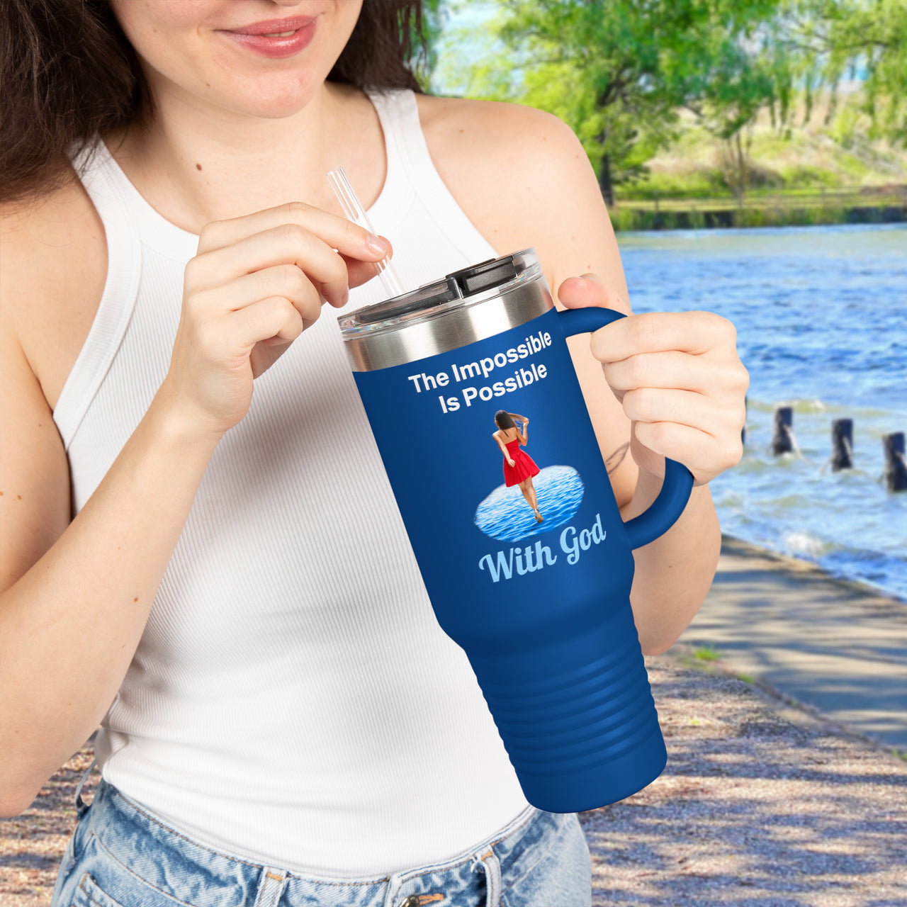 40oz inspirational travel mug with “Impossible Woman” design message "The Impossible Is Possible with God," faith-based tumbler for women, stainless steel, leak-proof, double-wall insulated, girl holding blue mug