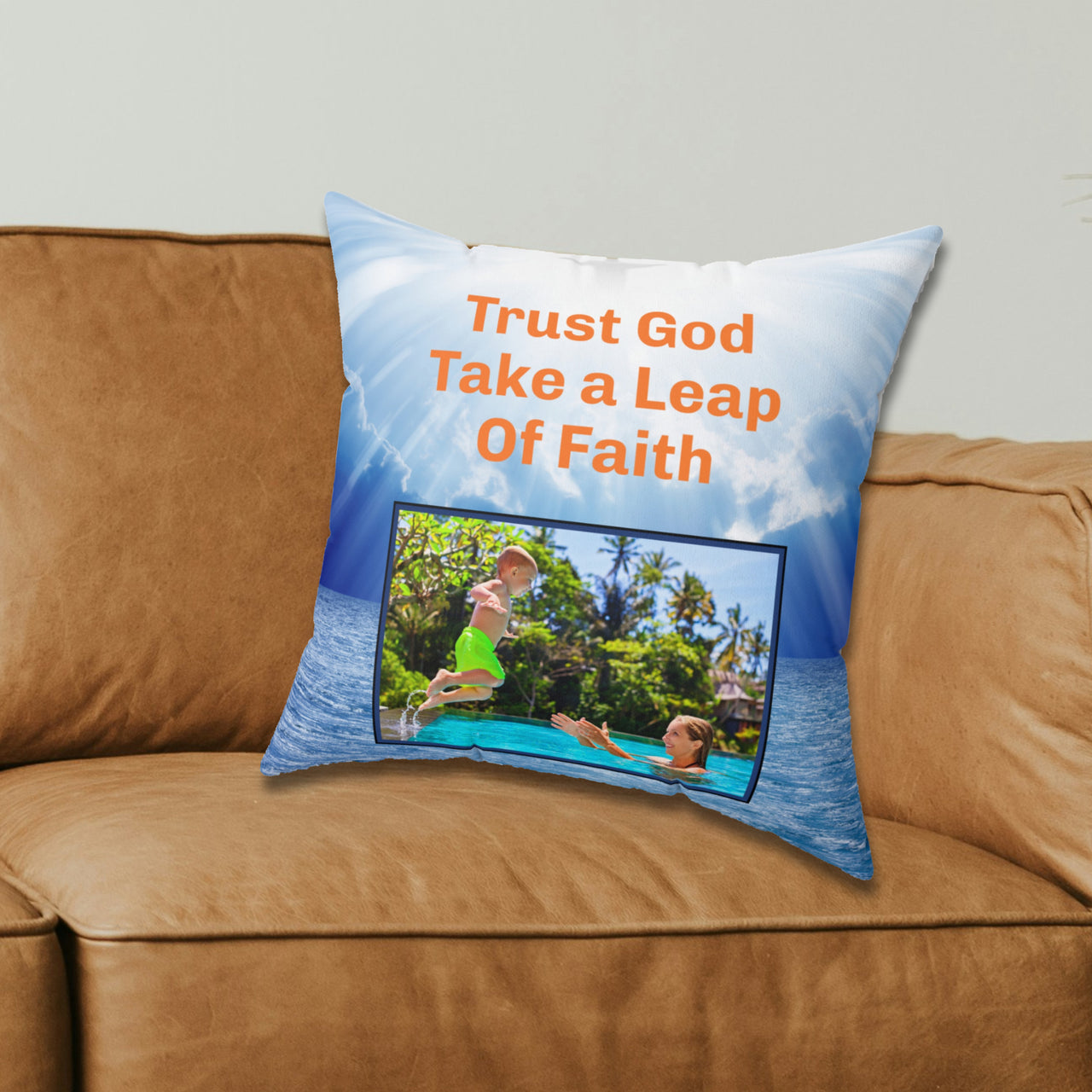 Inspirational throw pillow with “Leap of Faith” design, child jumping into pool, faith-based message "Trust God, Take a Leap of Faith," faith-based home décor, reversible with white or blue back, spun polyester, 4 sizes, 16x16 on couch