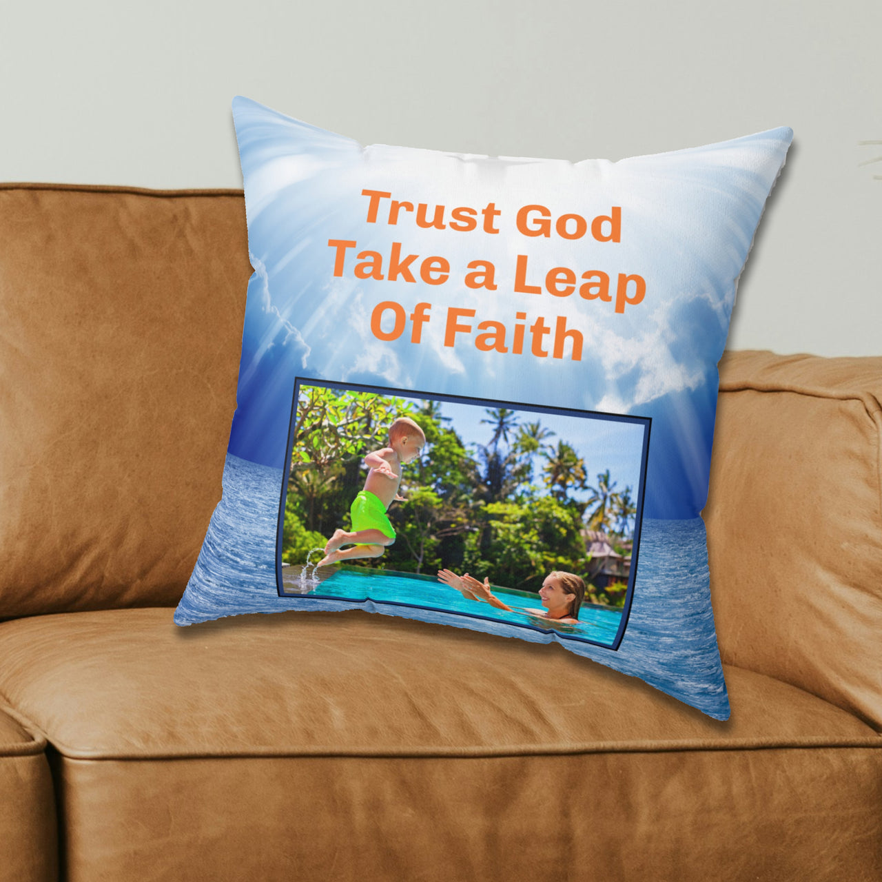 Inspirational throw pillow with “Leap of Faith” design, child jumping into pool, faith-based message "Trust God, Take a Leap of Faith," faith-based home décor, reversible with white or blue back, spun polyester, 4 sizes, 18x18 on couch