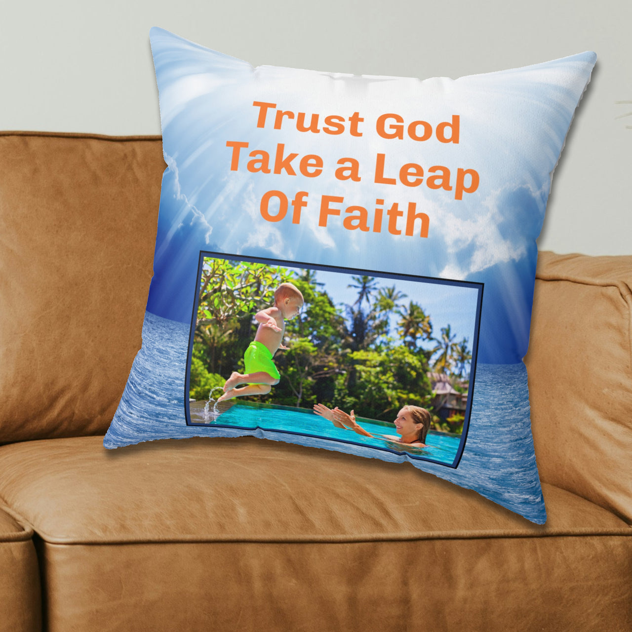 Inspirational throw pillow with “Leap of Faith” design, child jumping into pool, faith-based message "Trust God, Take a Leap of Faith," faith-based home décor, reversible with white or blue back, spun polyester, 4 sizes, 20x20 on couch