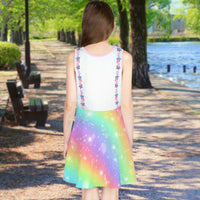 Pink girl's sundress with unicorn kitty and rainbow design, “Never Stop Dreaming” message, part of Paisley’s Treasure Chest Collection, lightweight polyester-spandex blend, ideal for summer and special occasions, back of girl in unicorn kitty sundress