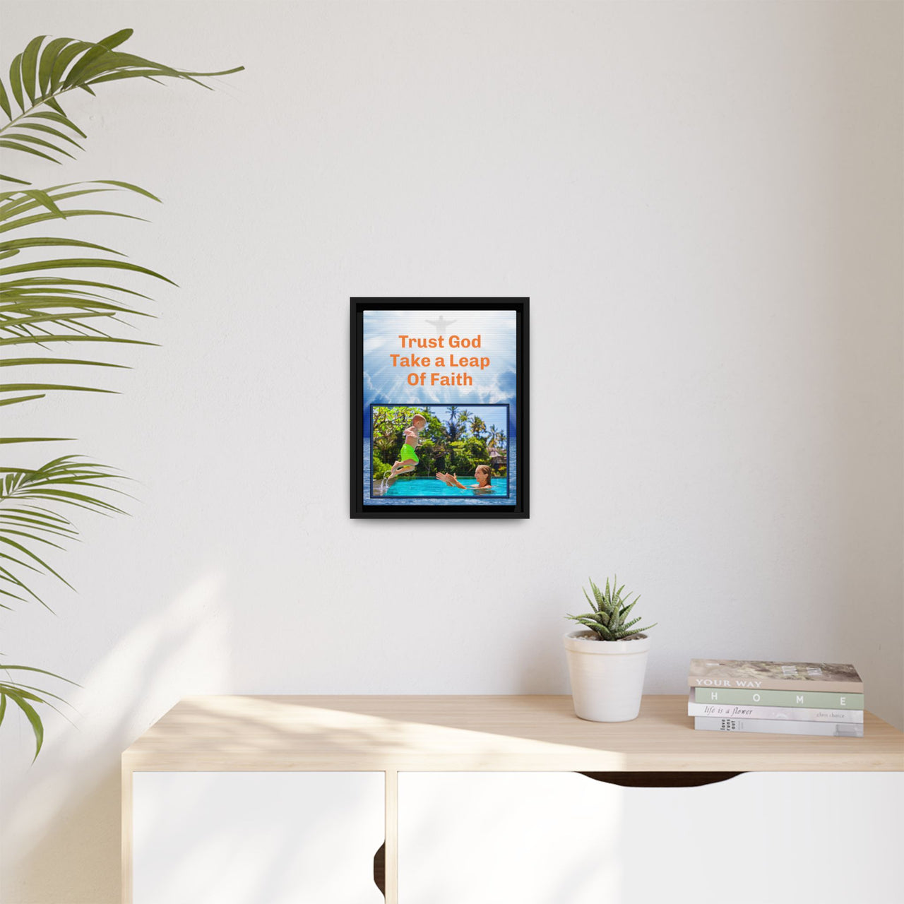 Framed canvas wall art with “Leap of Faith” design, child jumping into pool with message "Trust God, Take a Leap of Faith," faith-based décor, black pinewood frame, ready to hang, 11x14 framed wall art on wall