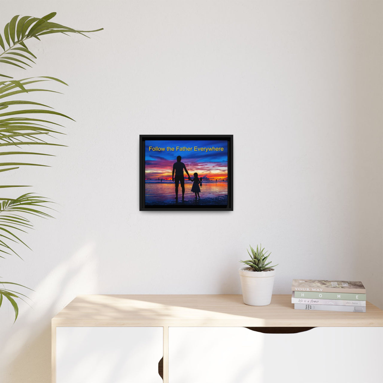 Framed canvas wall art with “Follow the Father” design, child walking with father with message "Follow the Father Everywhere," inspirational message, black pinewood frame, ready to hang, 14x11 framed wall art on wall
