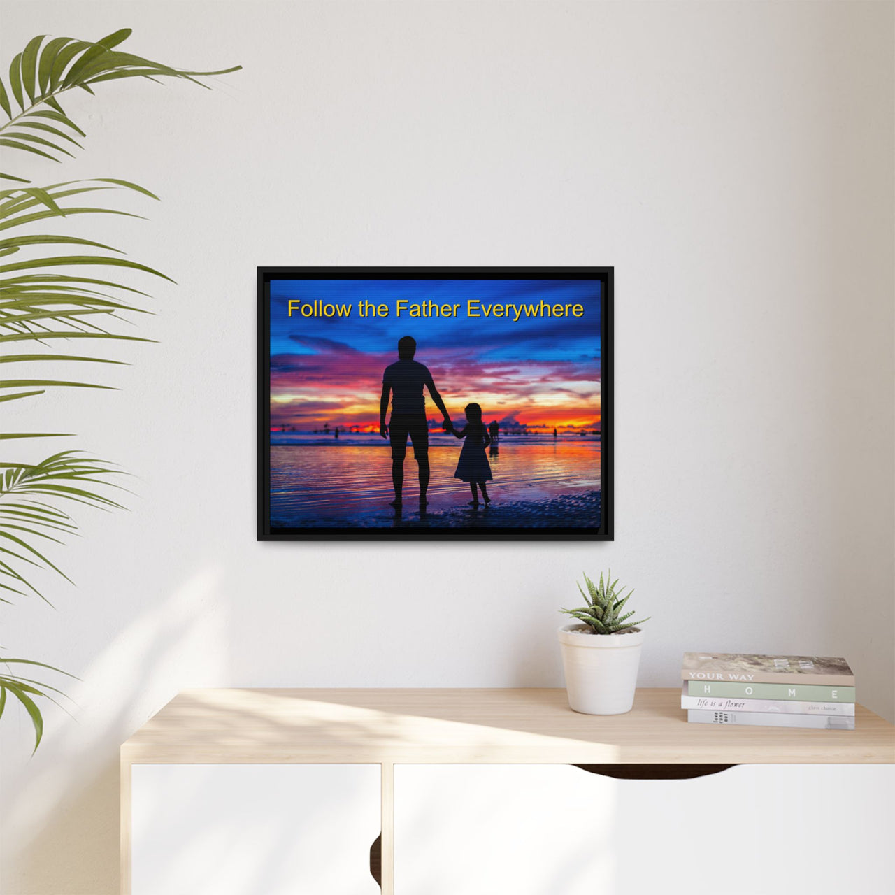 Framed canvas wall art with “Follow the Father” design, child walking with father with message "Follow the Father Everywhere," inspirational message, black pinewood frame, ready to hang, 24x18 framed wall art on wall