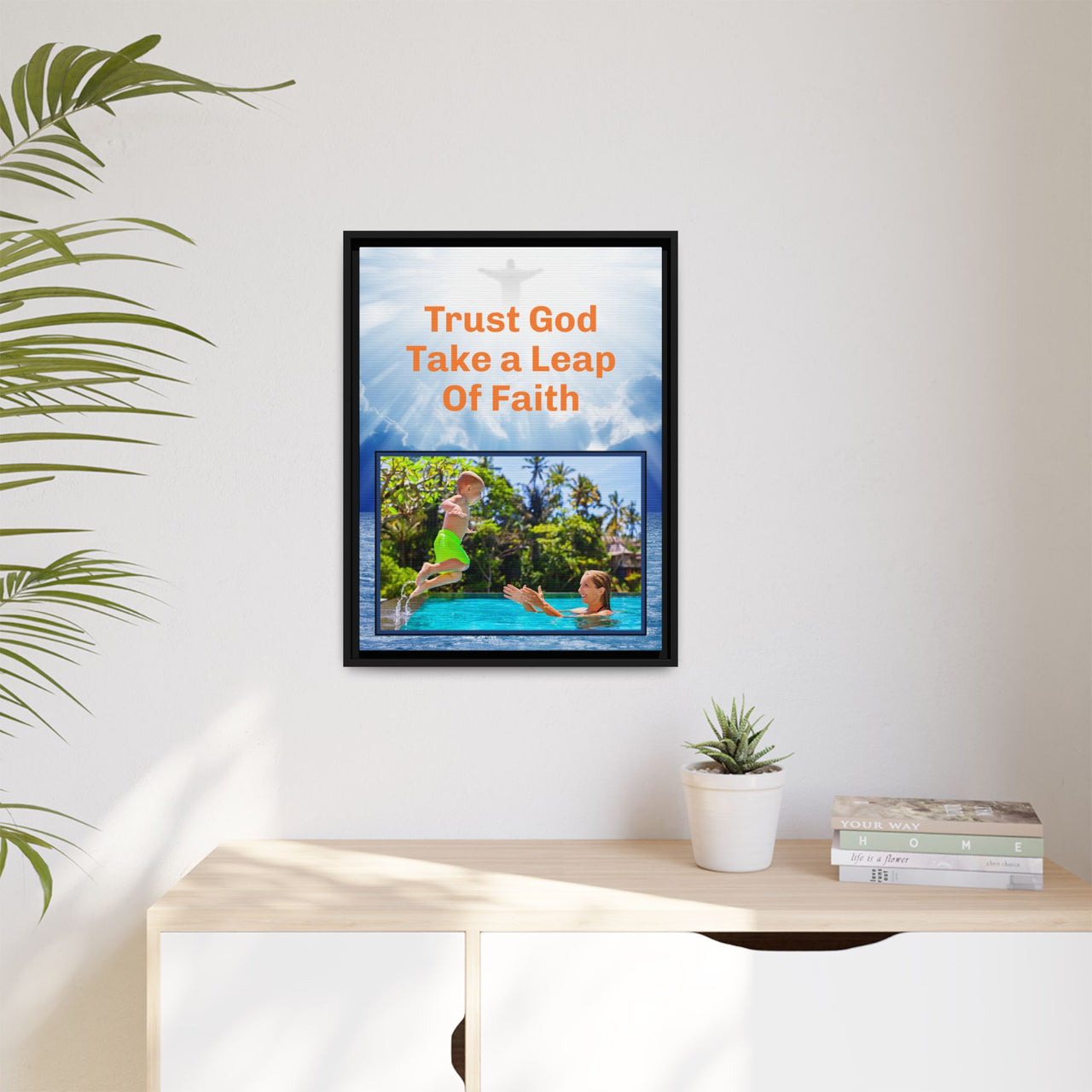 Framed canvas wall art with “Leap of Faith” design, child jumping into pool with message "Trust God, Take a Leap of Faith," faith-based décor, black pinewood frame, ready to hang, 18x24 framed wall art on wall
