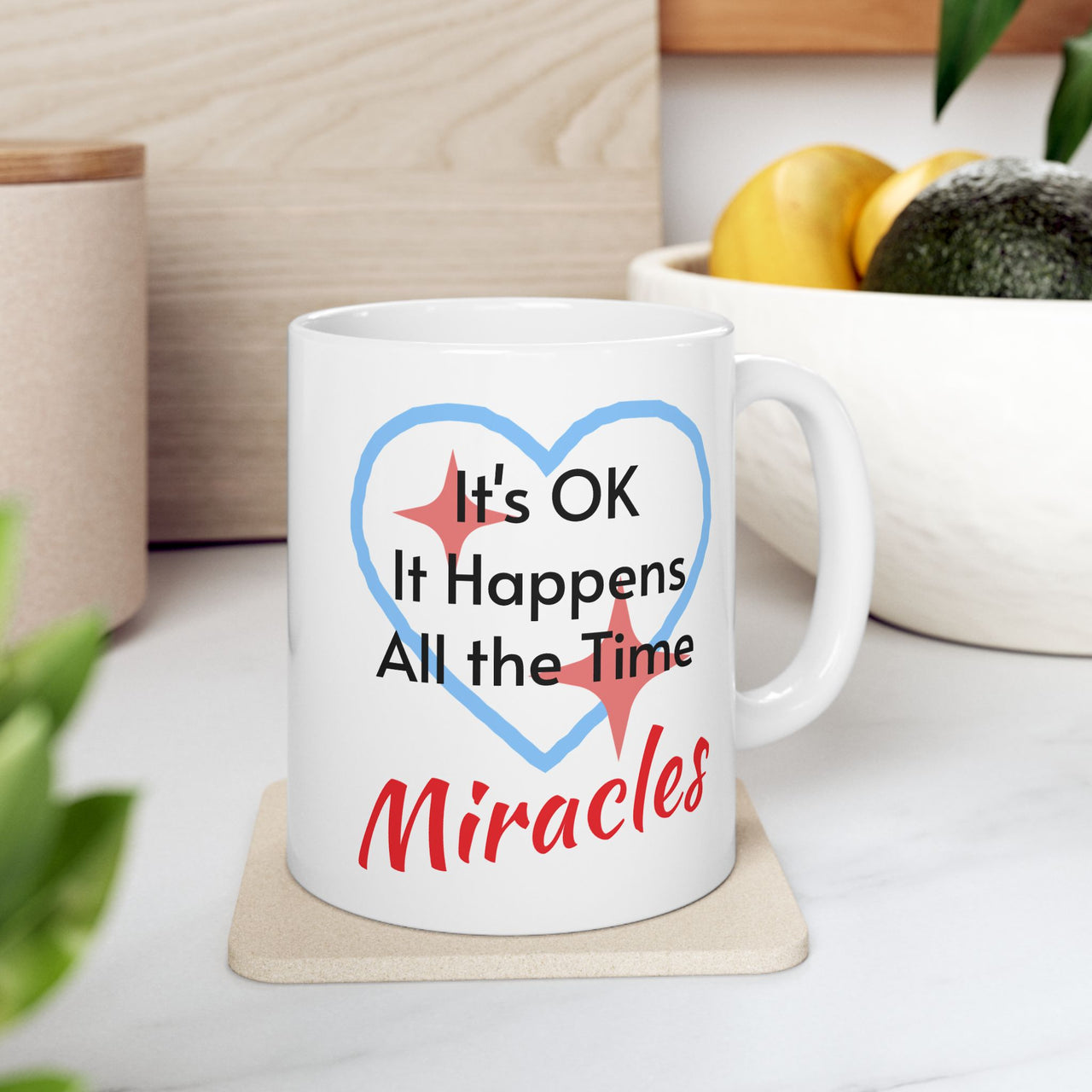 Inspirational faith-based ceramic mug with “Miracles Happen” design with message "It's Ok, It Happens All the Time - Miracles," Christian gift, microwave safe, dishwasher safe, 11oz and 15oz, 11 oz mug on table