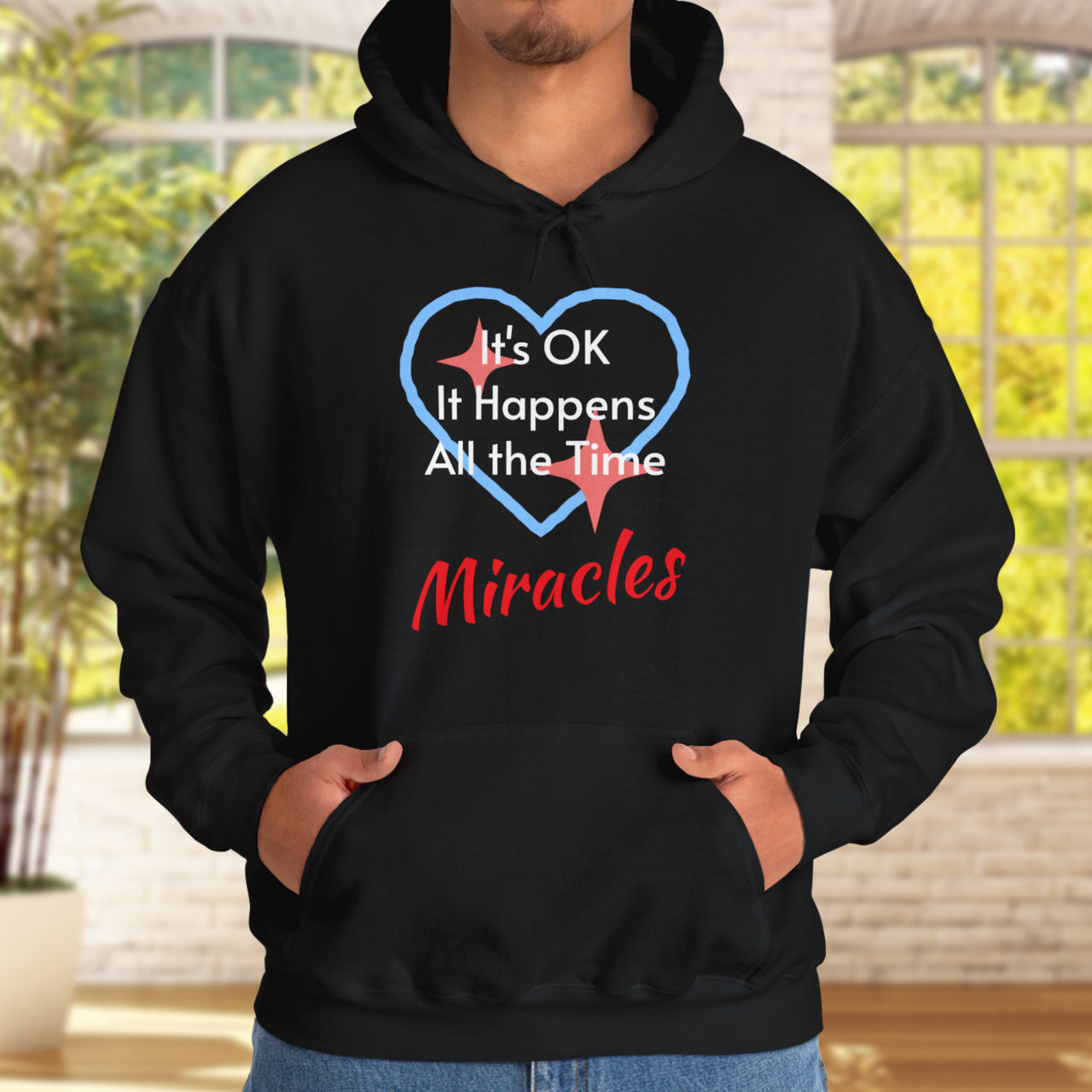 Gildan unisex hoodie with “Miracles Happen” design and uplifting message, Christian apparel made from soft cotton-poly blend, ideal for cooler weather and faith-inspired comfort, man in gray hoodie