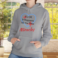 Gildan unisex hoodie with “Miracles Happen” design and uplifting message, Christian apparel made from soft cotton-poly blend, ideal for cooler weather and faith-inspired comfort, woman in gray hoodie