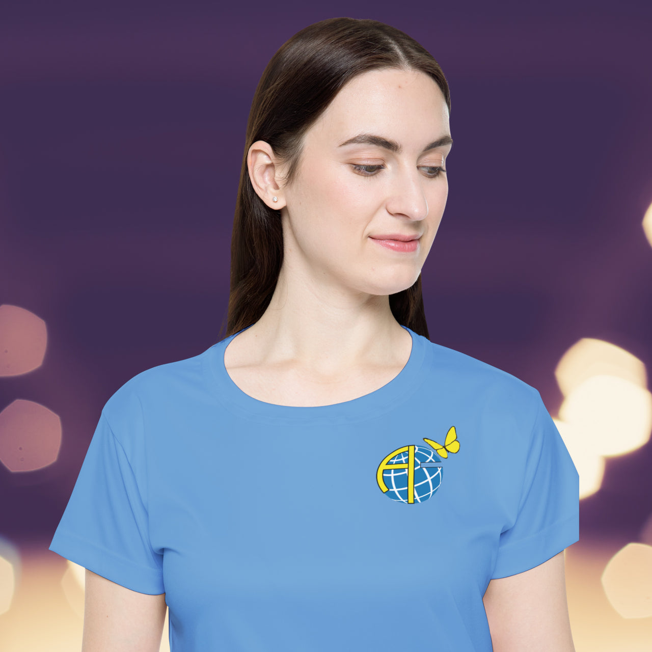Women’s sport jersey with Anakainoo International logo, breathable moisture-wicking fabric with globe and butterfly design symbolizing spiritual transformation and renewal through intimacy with God, close-up of logo on light-blue sport jersey