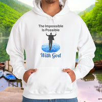 Gildan unisex hoodie with “Impossible Man” design featuring a man walking on water and uplifting message, Christian apparel made from soft cotton-poly blend, perfect for cold weather and spiritual encouragement, man in white hoodie