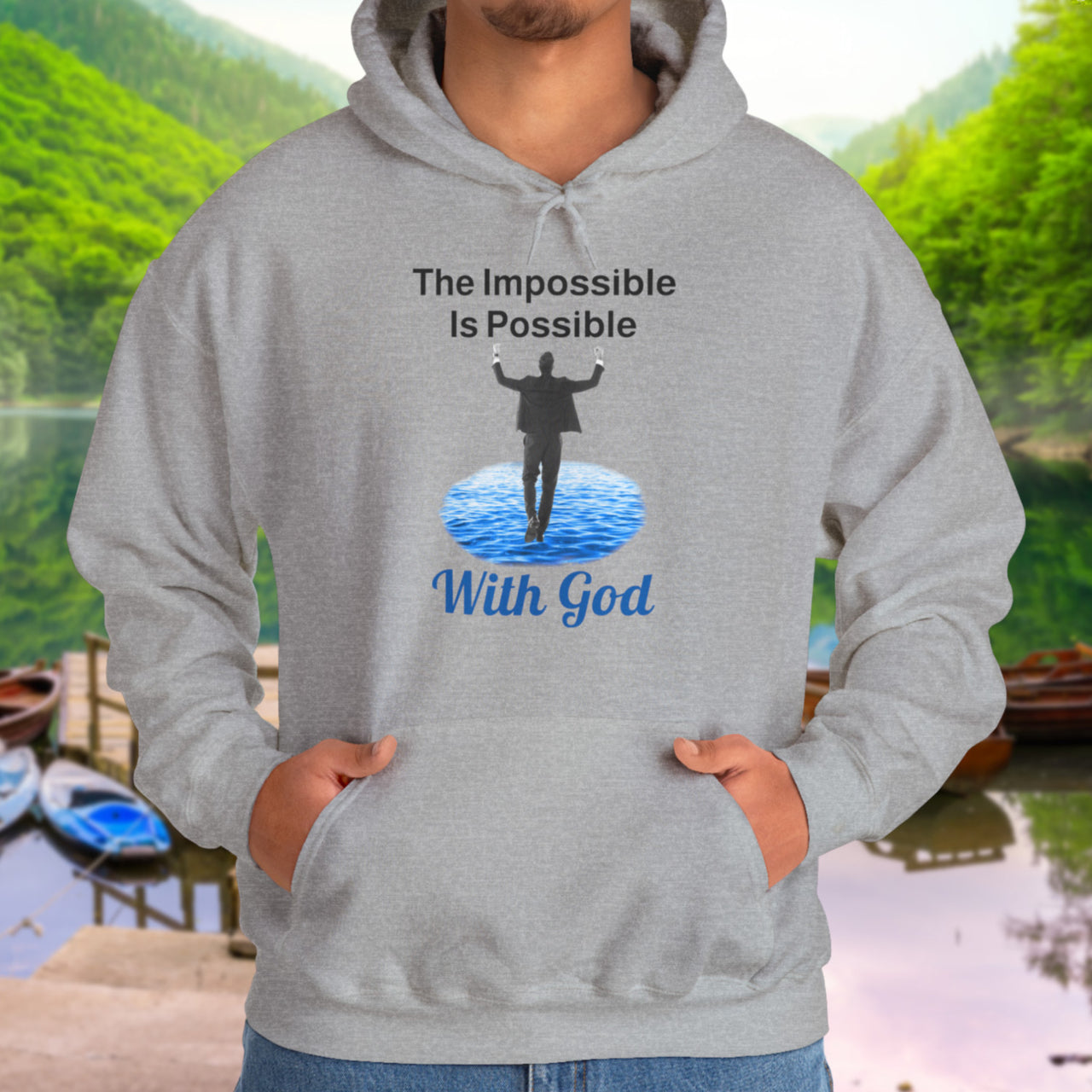 Gildan unisex hoodie with “Impossible Man” design featuring a man walking on water and uplifting message, Christian apparel made from soft cotton-poly blend, perfect for cold weather and spiritual encouragement, man in gray hoodie