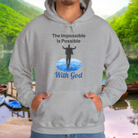 Gildan unisex hoodie with “Impossible Man” design featuring a man walking on water and uplifting message, Christian apparel made from soft cotton-poly blend, perfect for cold weather and spiritual encouragement, man in gray hoodie